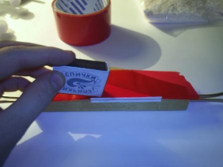 Now, for the selected adhesion of the adhesive tape to the surface of the stabilizer, we iron it with a matchbox.